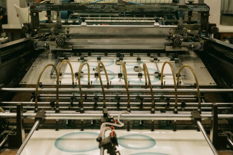Close-up of an industrial printing press producing designs.